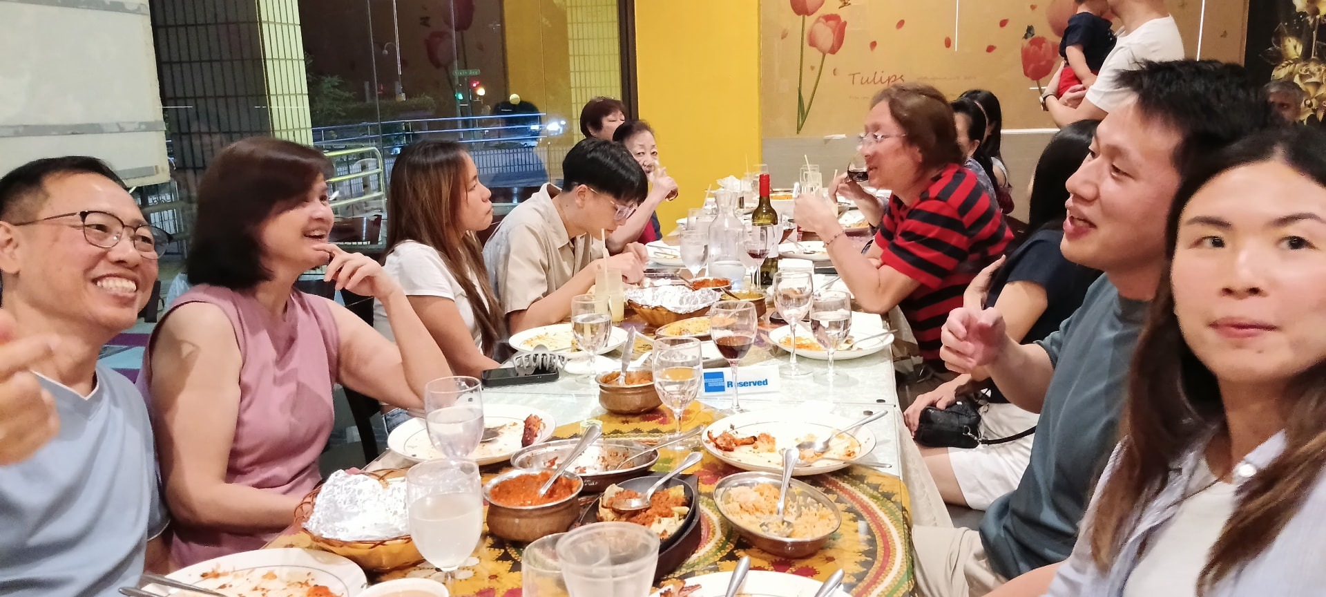 A large family group enjoying a shared Indian meal at Indian Curry House