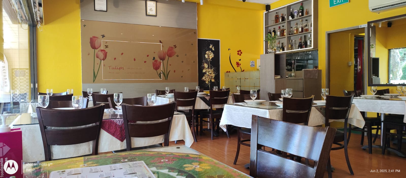 Dining area with tulip wall art and bar shelves